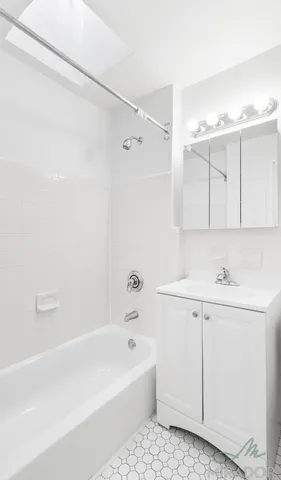 a bathroom with a bathtub a sink and a shower