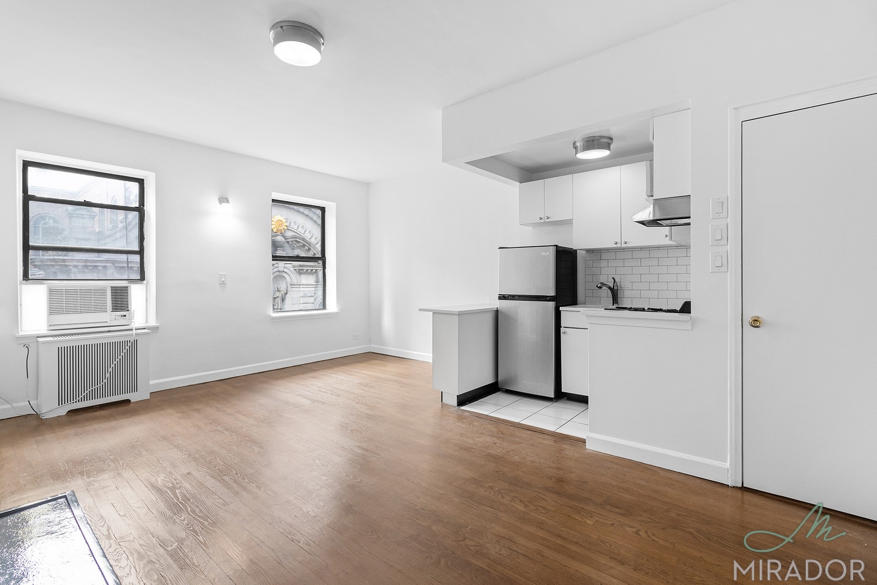 39 West 16th Street, Unit 5F Manhattan, NY 10011 - Photo 7 of 11 a view of a kitchen with wooden floor and windows