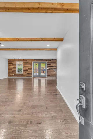 an empty room with window and ceiling fan