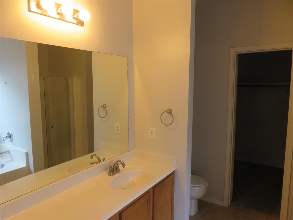 2026 Tanur Cascade Drive Anna, TX 75409 - Photo 12 of 24 a bathroom with a sink and a mirror