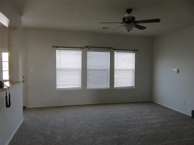 an empty room with a empty space and windows
