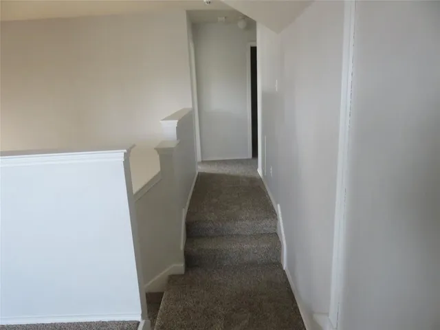 a view of a hallway with staircase