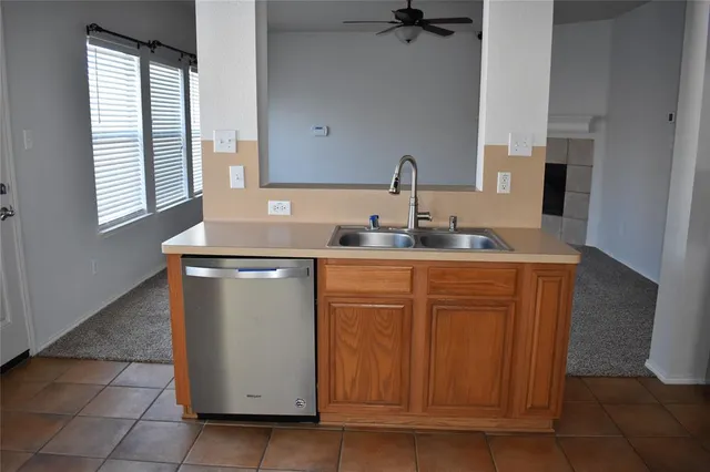 a kitchen with stainless steel appliances granite countertop a sink and cabinets