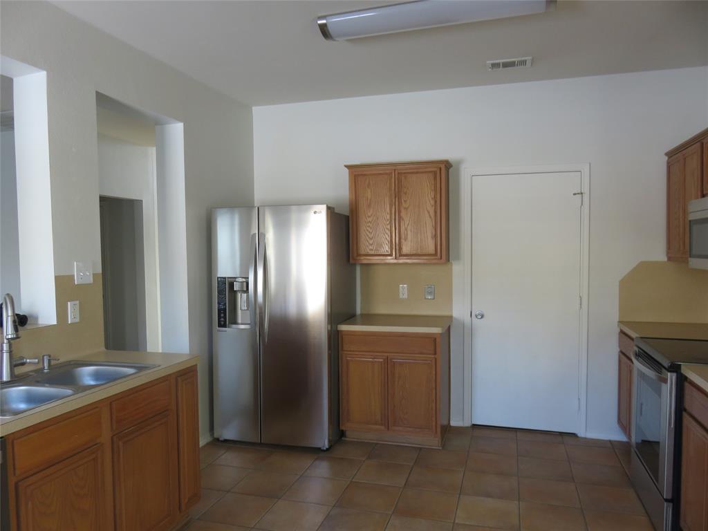 2026 Tanur Cascade Drive Anna, TX 75409 - Photo 5 of 24 a kitchen with stainless steel appliances granite countertop a refrigerator and a sink