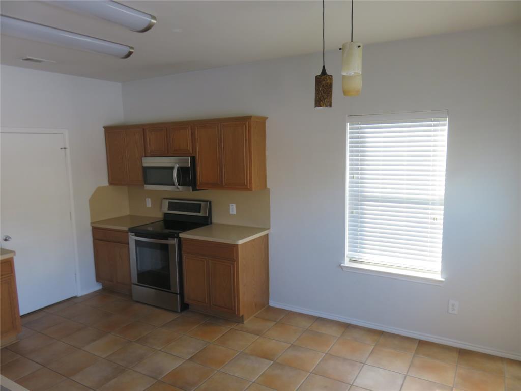 2026 Tanur Cascade Drive Anna, TX 75409 - Photo 6 of 24 a kitchen with stainless steel appliances granite countertop a sink a stove and a refrigerator