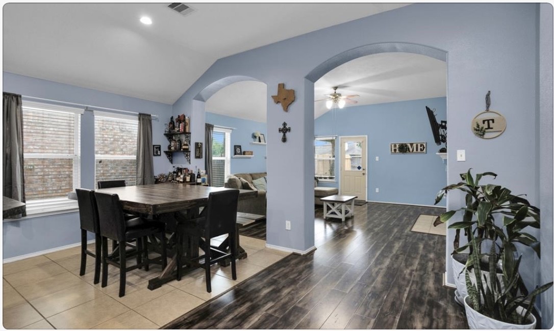 5015 Bridgecrossing Court Spring, TX 77379 - Photo 4 of 12 a view of a dining room with furniture and wooden floor