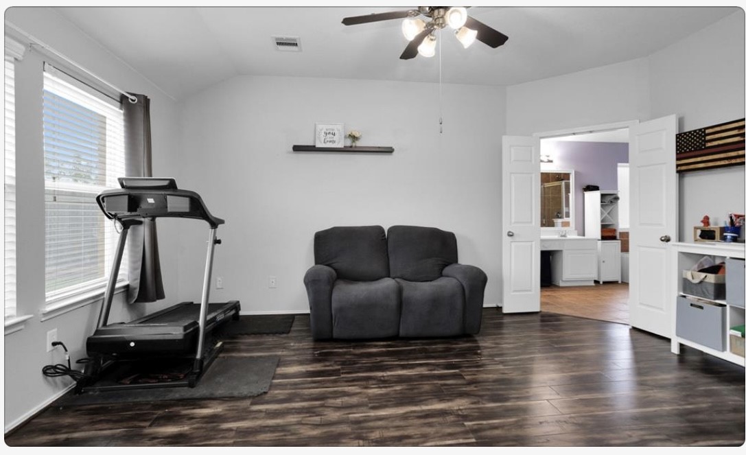 5015 Bridgecrossing Court Spring, TX 77379 - Photo 8 of 12 a living room with furniture and a wooden floor
