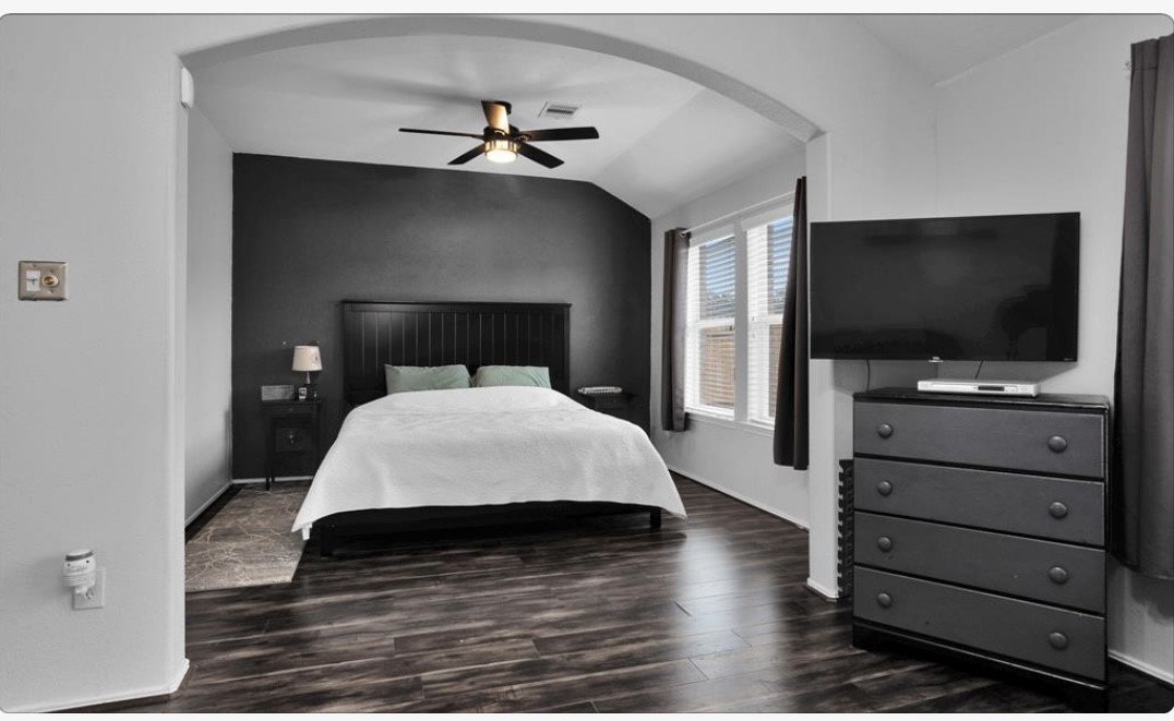 5015 Bridgecrossing Court Spring, TX 77379 - Photo 9 of 12 a bedroom with a bed and a flat tv screen on dresser