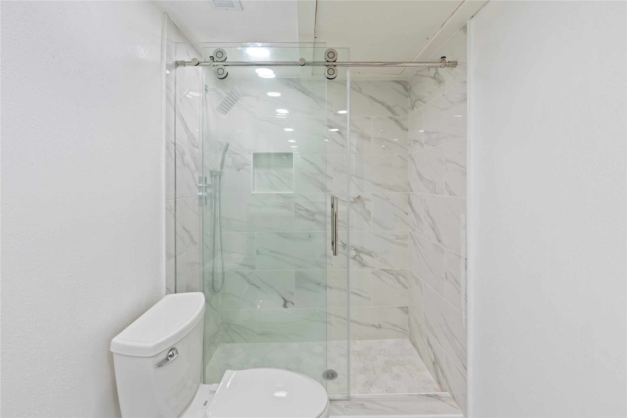6001 Reims Road, Unit 1412 Houston, TX 77036 - Photo 11 of 28 a bathroom with a shower and toilet
