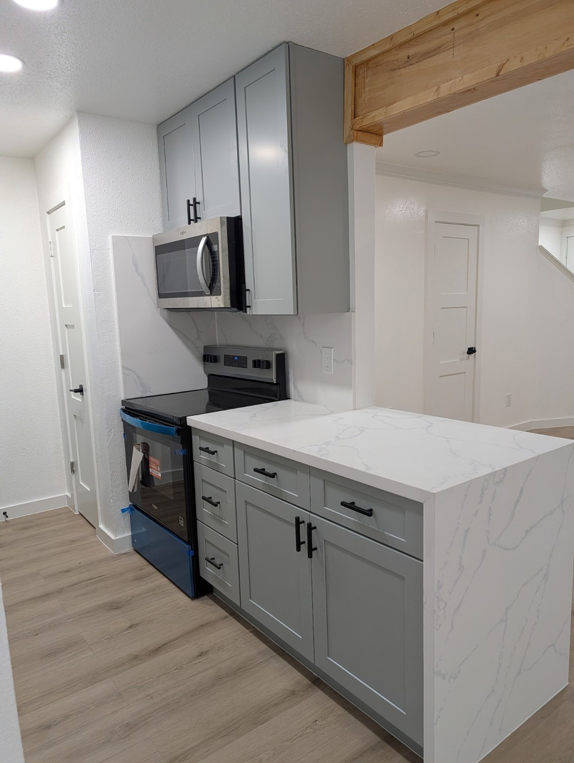 6001 Reims Road, Unit 1412 Houston, TX 77036 - Photo 17 of 28 a kitchen with a sink cabinets and wooden floor