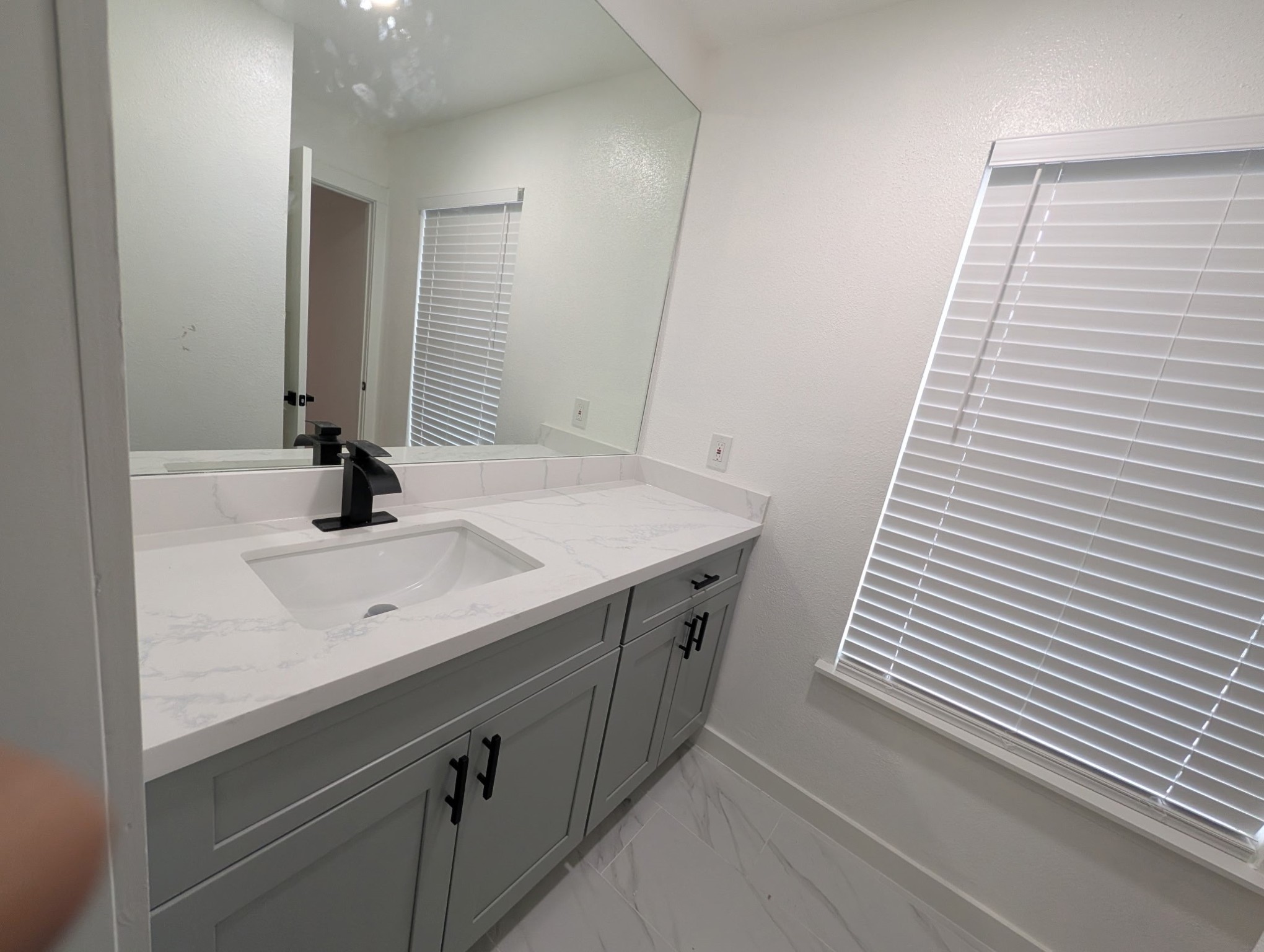 6001 Reims Road, Unit 1412 Houston, TX 77036 - Photo 18 of 28 a bathroom with a sink and a mirror