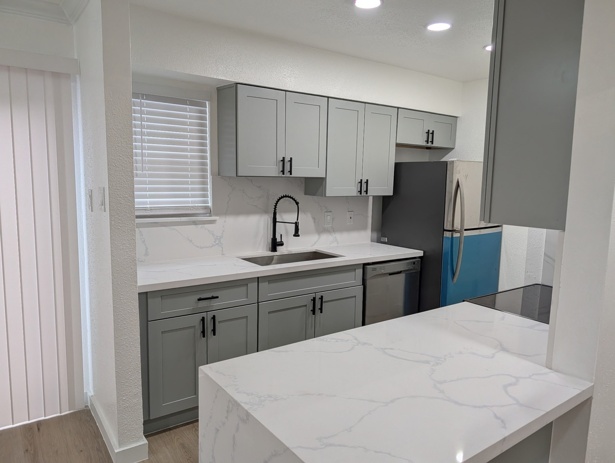 6001 Reims Road, Unit 1412 Houston, TX 77036 - Photo 2 of 28 a kitchen with a sink a refrigerator and cabinets