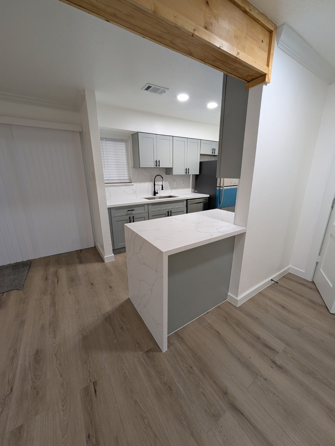 6001 Reims Road, Unit 1412 Houston, TX 77036 - Photo 23 of 28 a view of a kitchen with wooden floor and electronic appliances