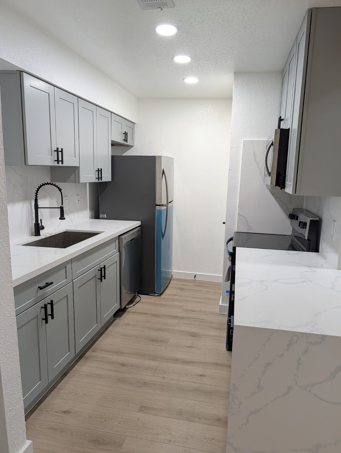 6001 Reims Road, Unit 1412 Houston, TX 77036 - Photo 24 of 28 a kitchen with a sink appliances and cabinets