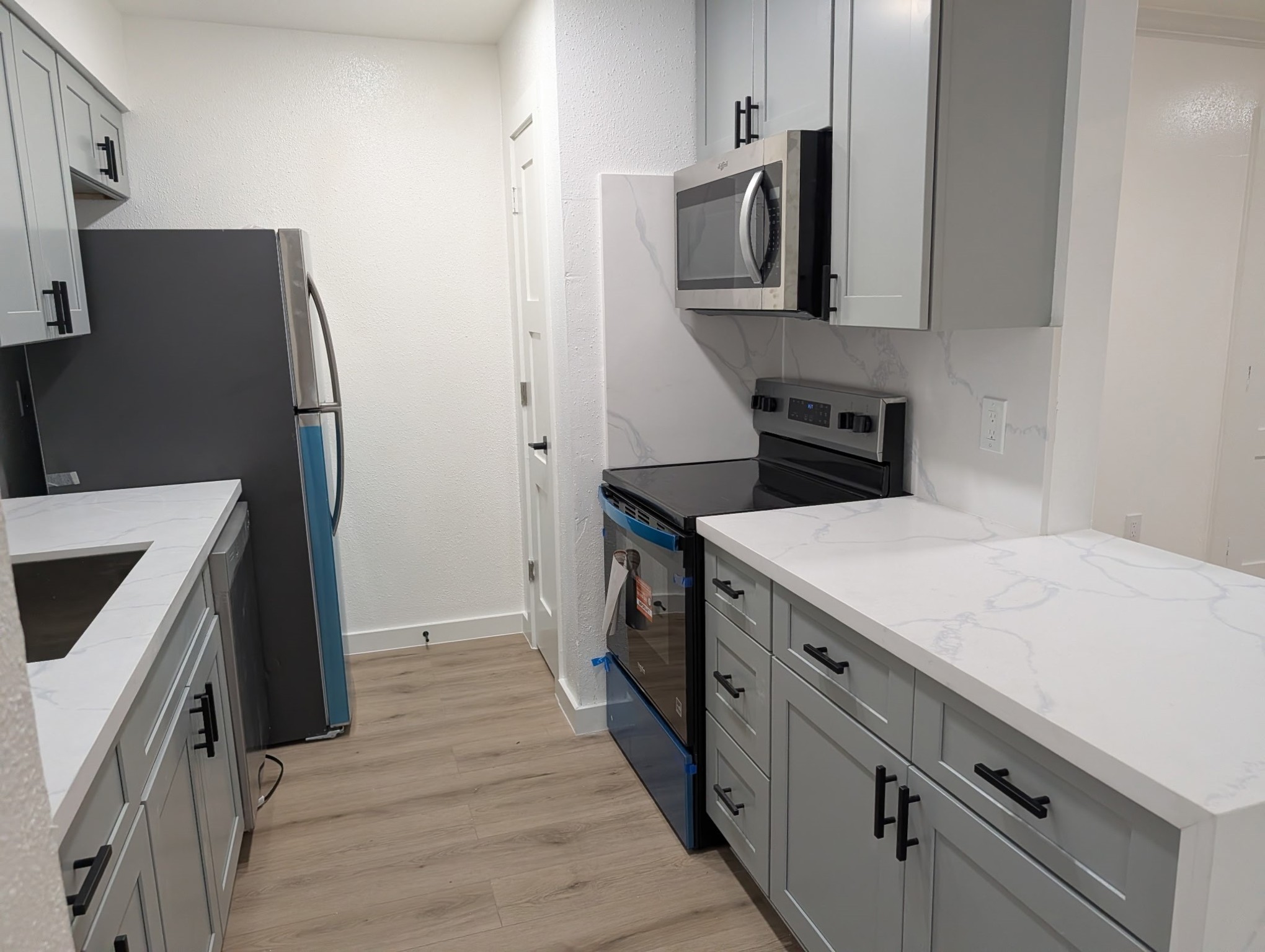 6001 Reims Road, Unit 1412 Houston, TX 77036 - Photo 25 of 28 a kitchen with a sink stove and refrigerator