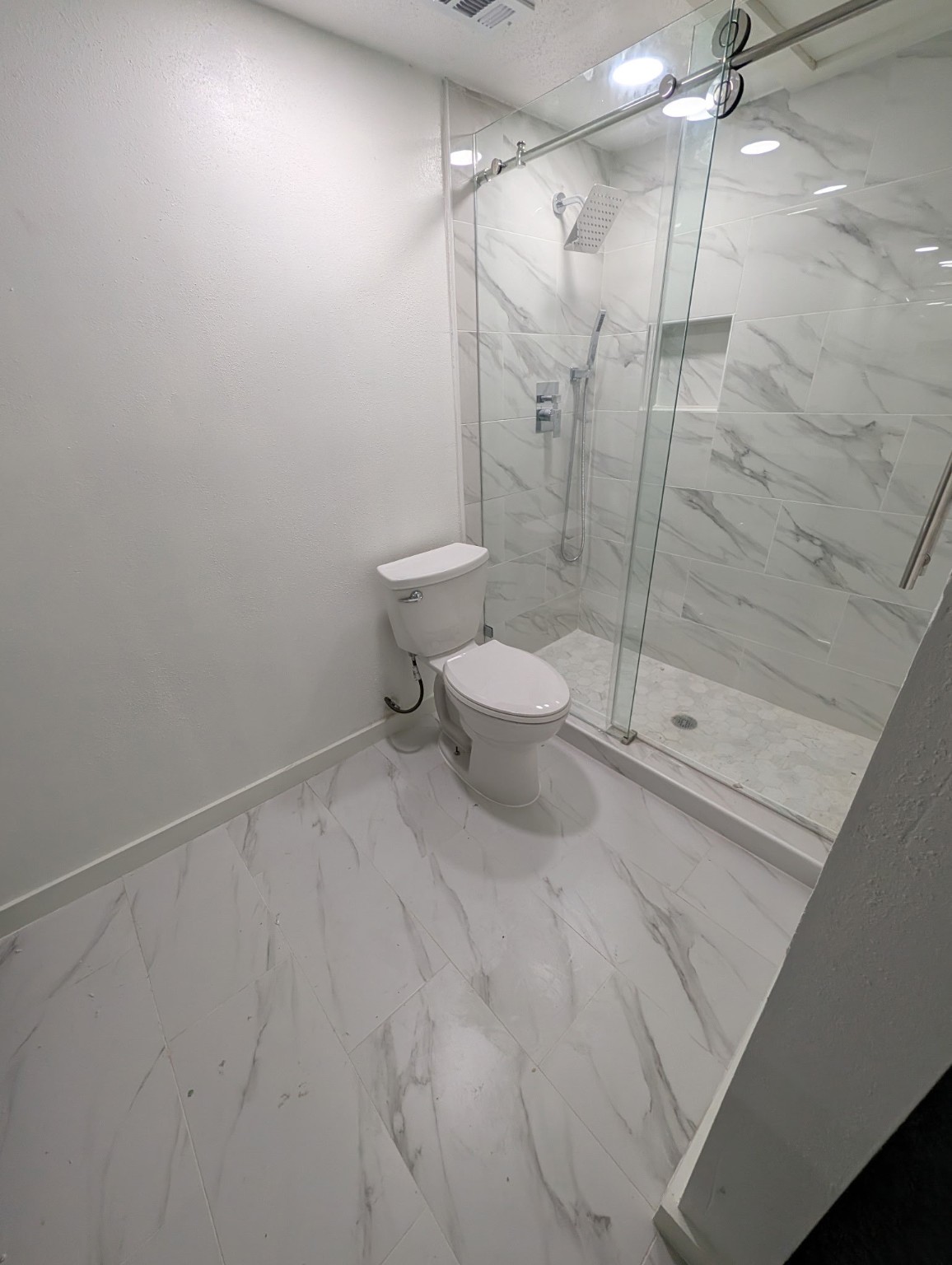 6001 Reims Road, Unit 1412 Houston, TX 77036 - Photo 26 of 28 a bathroom with a toilet and a shower