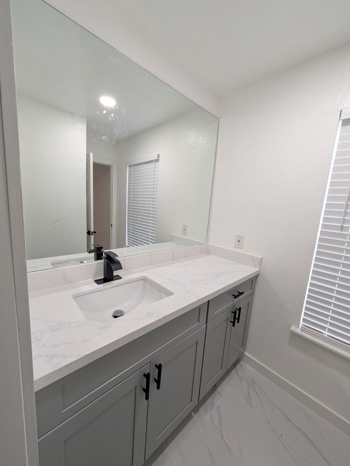 6001 Reims Road, Unit 1412 Houston, TX 77036 - Photo 28 of 28 a bathroom with a sink and a mirror