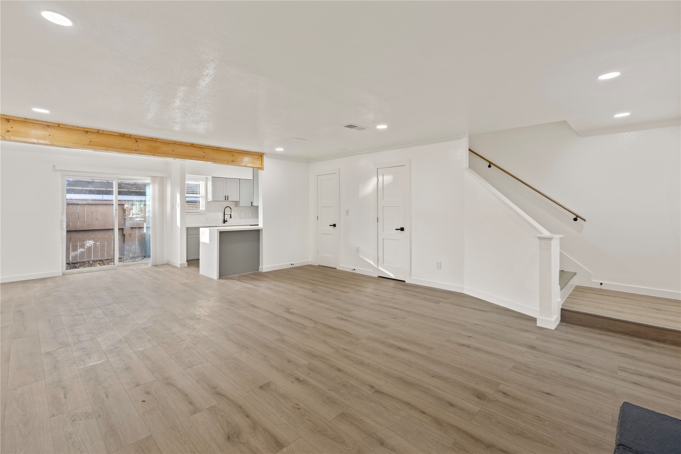 6001 Reims Road, Unit 1412 Houston, TX 77036 - Photo 3 of 28 a view of empty room with wooden floor and kitchen