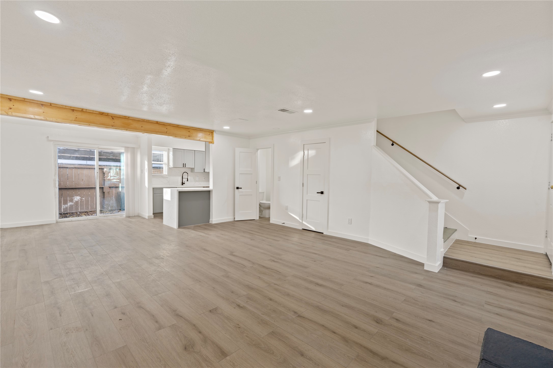 6001 Reims Road, Unit 1412 Houston, TX 77036 - Photo 4 of 28 a view of empty room with wooden floor and kitchen