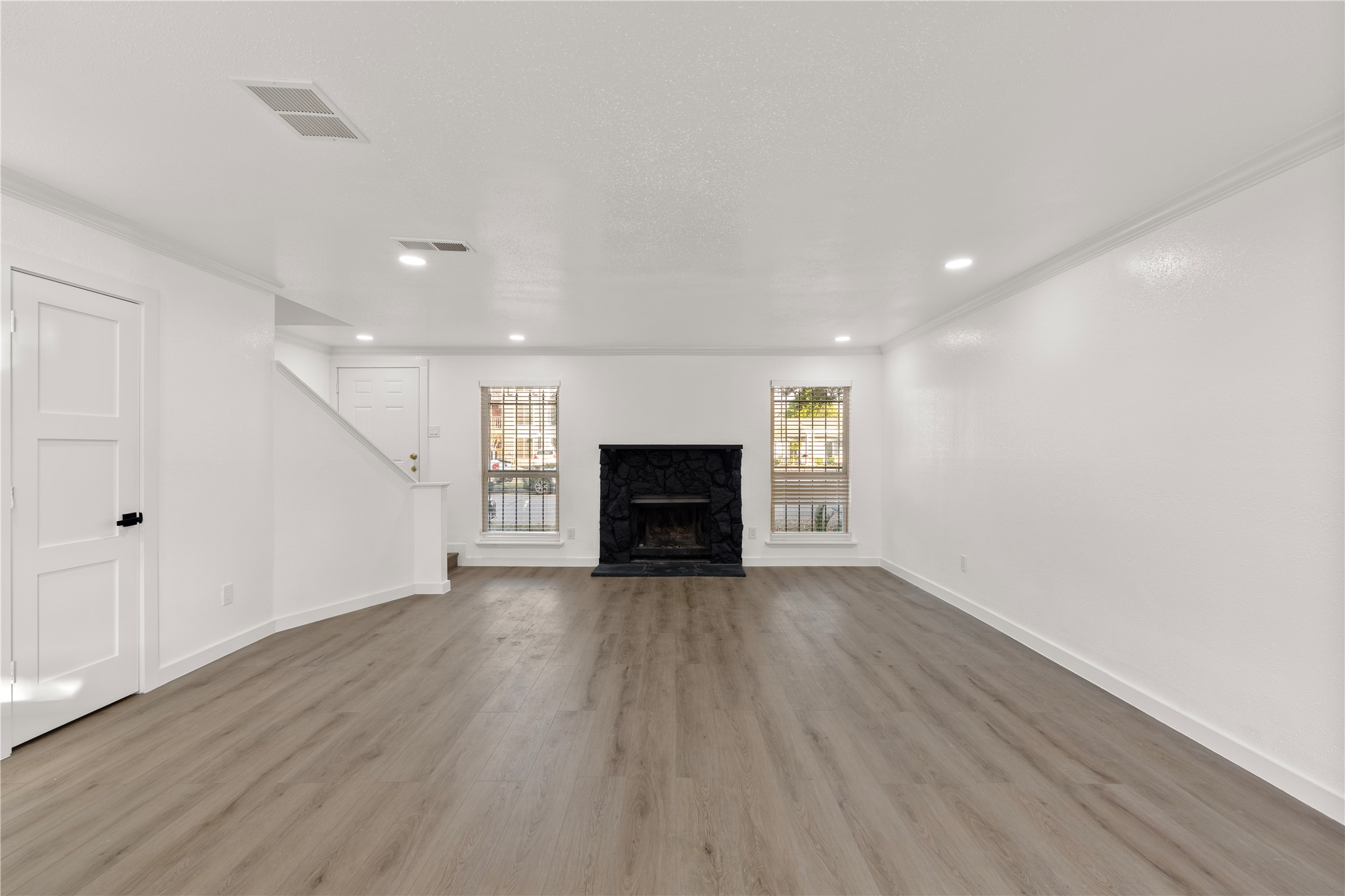 6001 Reims Road, Unit 1412 Houston, TX 77036 - Photo 7 of 28 wooden floor in an empty room with a fireplace