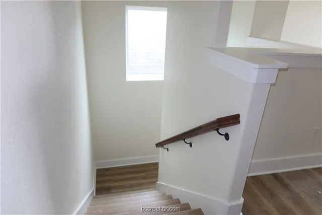 a view of entryway with stairs and wooden floor