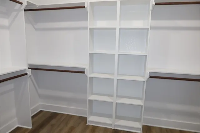 a view of walk in closet with empty racks