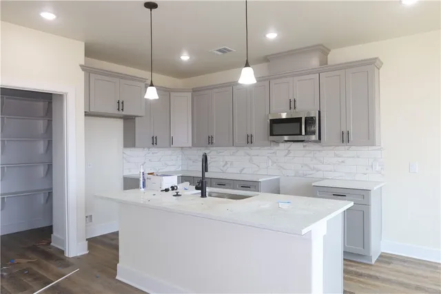 a kitchen with a sink a refrigerator and a stove