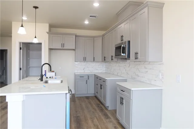 a kitchen with a sink cabinets and window