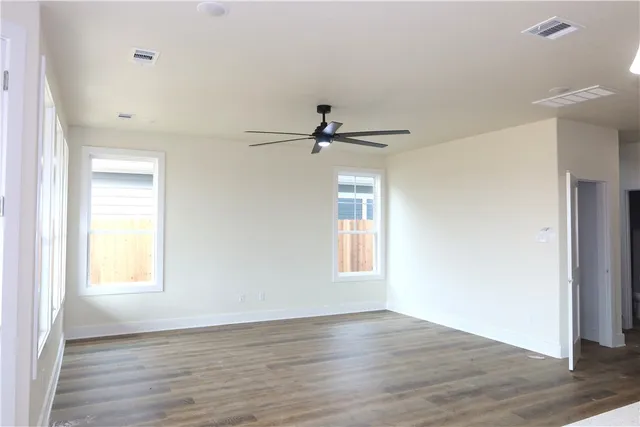 a view of a livingroom with wooden floor and a window