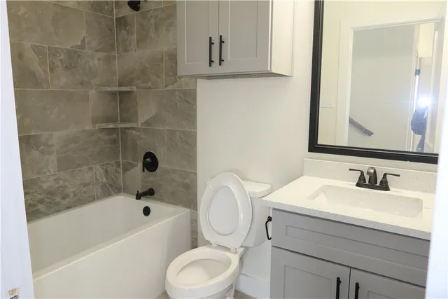 a bathroom with a sink a toilet and bathtub