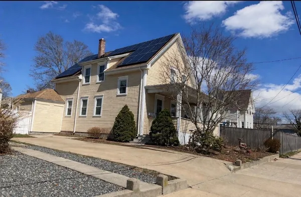 a front view of a house with a yard