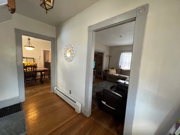 a view of a hallway and a livingroom with furniture