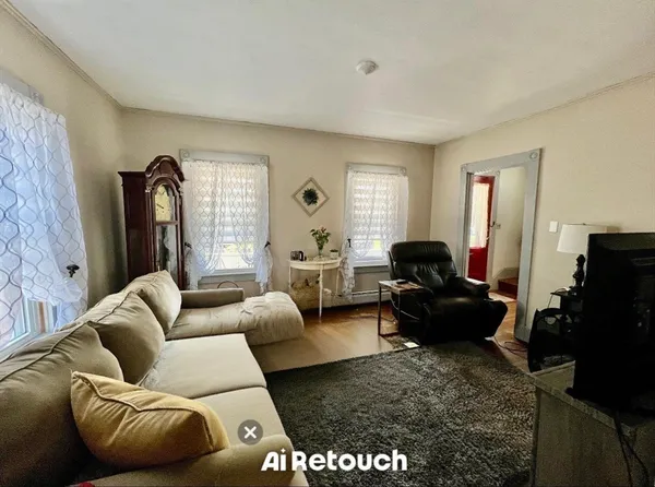 a living room with furniture windows and a flat screen tv