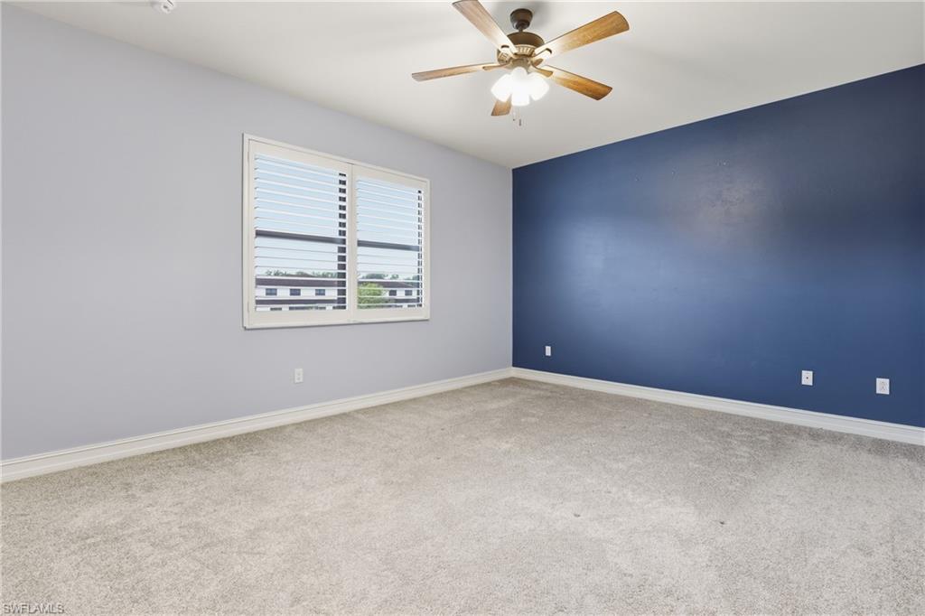 7894 Bristol Circle Naples, FL 34120 - Photo 13 of 29 an empty room with windows and fan
