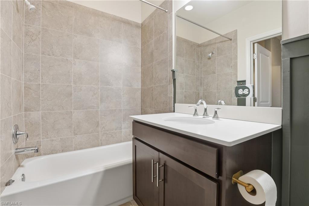 7894 Bristol Circle Naples, FL 34120 - Photo 19 of 29 a bathroom with a sink and a bathtub