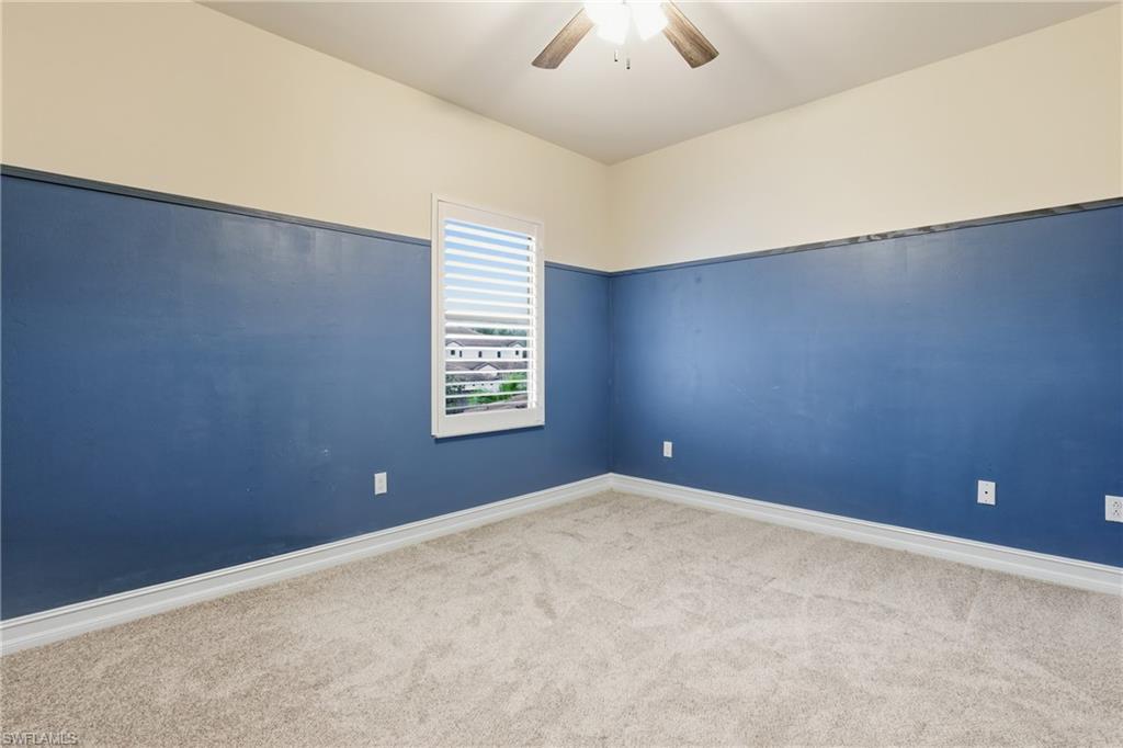 7894 Bristol Circle Naples, FL 34120 - Photo 20 of 29 an empty room with windows and fan