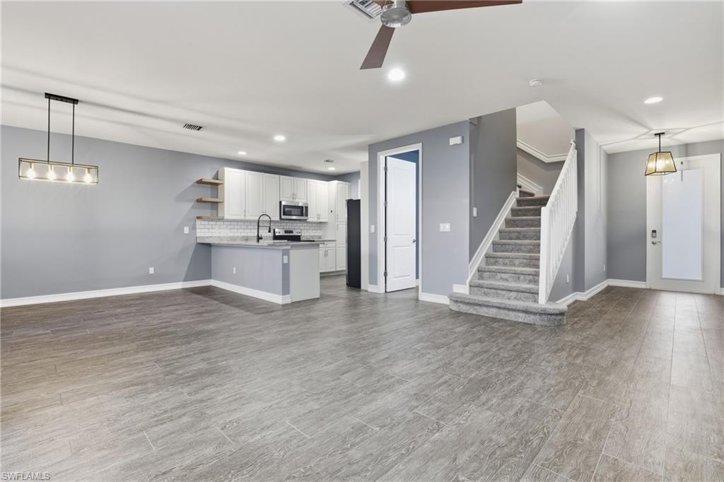 7894 Bristol Circle Naples, FL 34120 - Photo 2 of 29 a view of a kitchen with a sink wooden floor and staircase