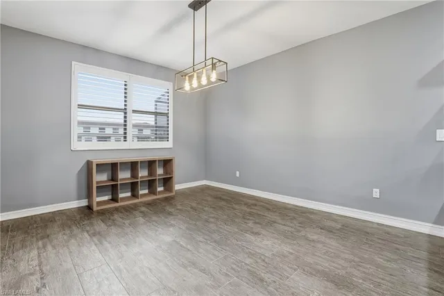 a view of a room with a window and wooden floor