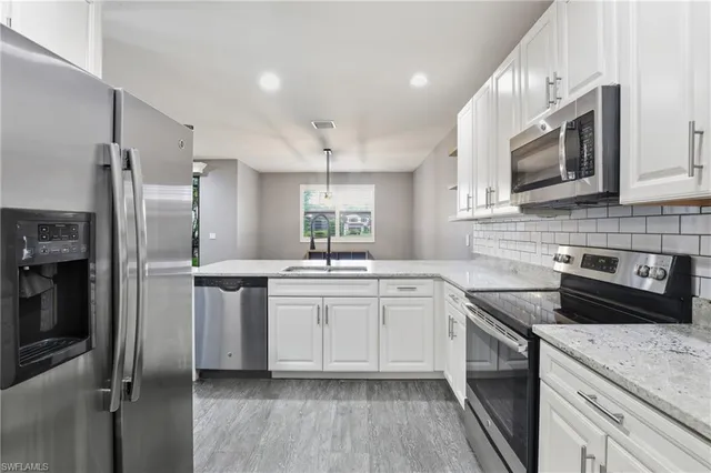 a kitchen with a sink stove and refrigerator