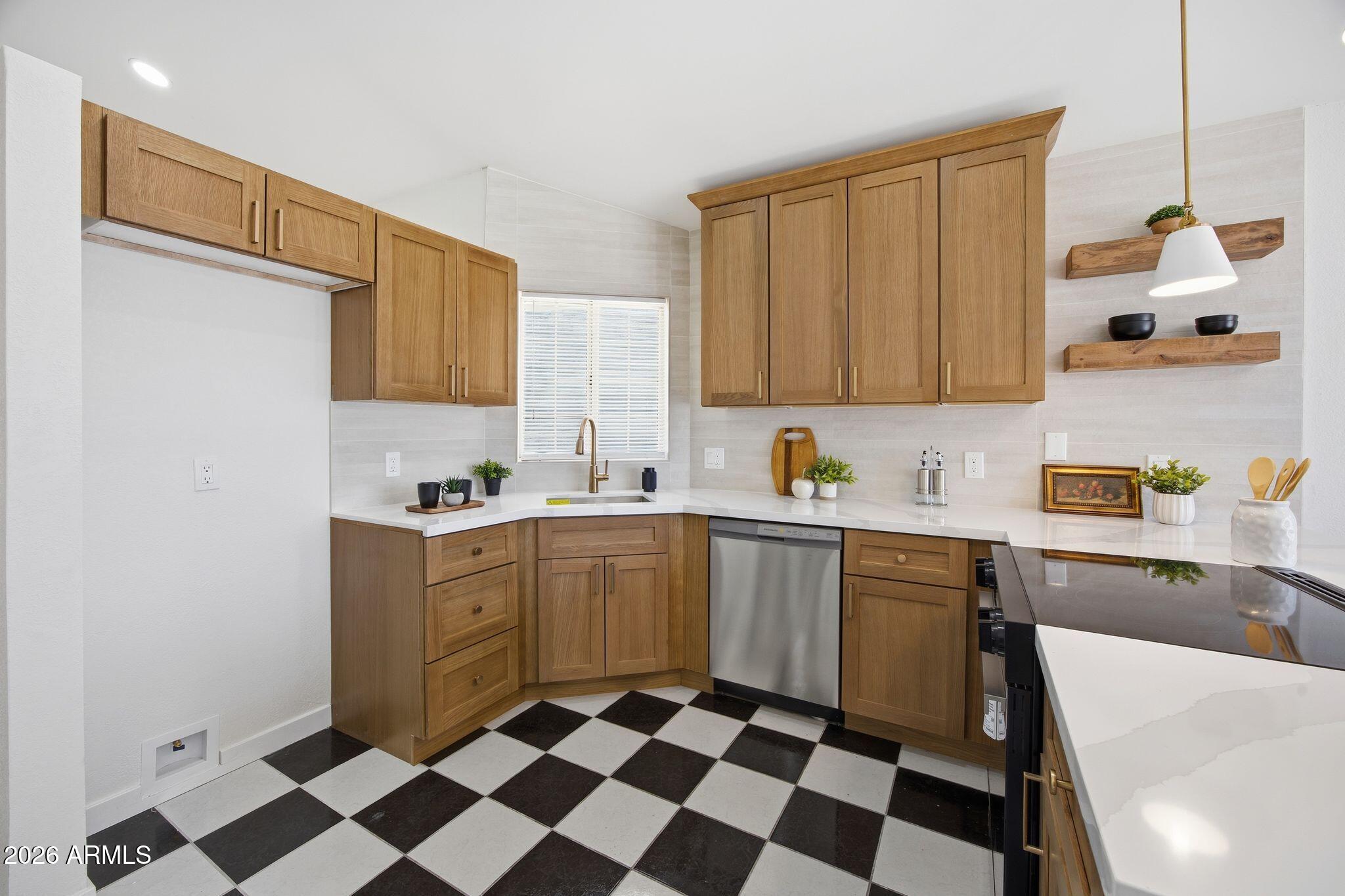 3134 East McKellips Road, Unit 69 Mesa, AZ 85213 - Photo 8 of 24 a kitchen with a checkered floor and white appliances