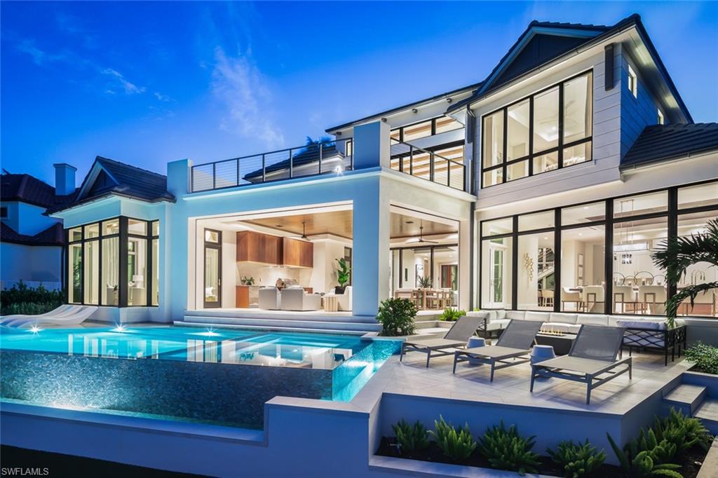 a view of a patio with couches table and chairs and potted plants