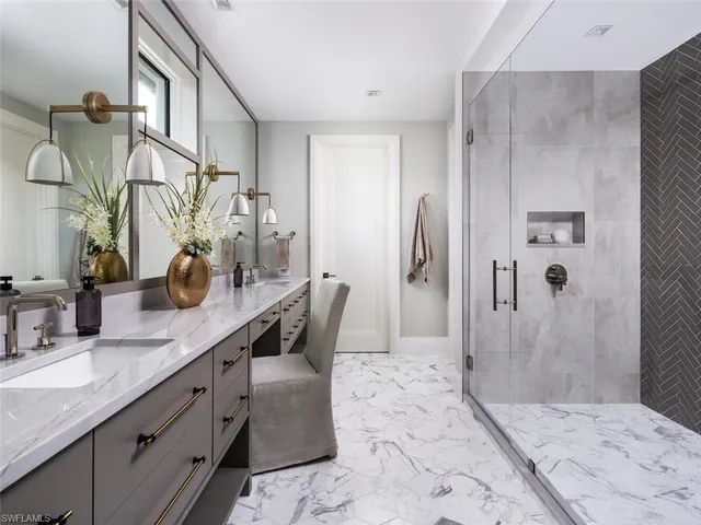 a bathroom with a double vanity sink mirror and shower