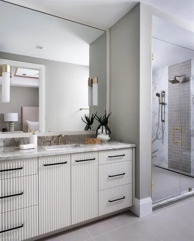 a bathroom with a granite countertop sink and a mirror