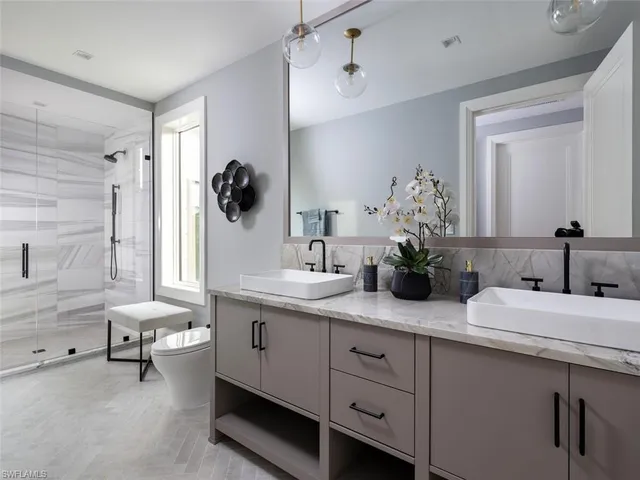 a bathroom with a double vanity sink and a mirror