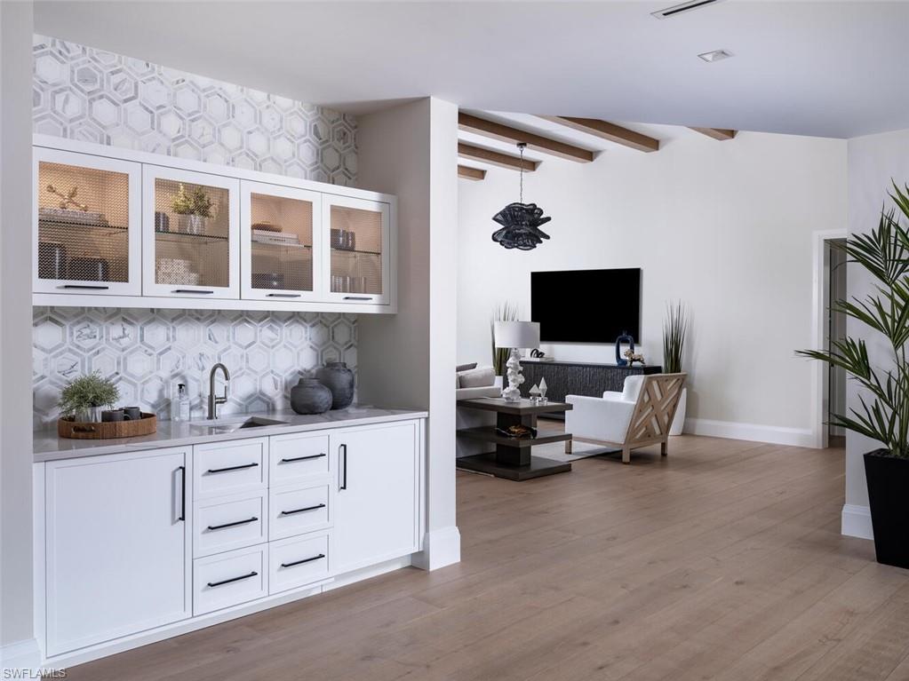 3131 Gin Lane Naples, FL 34102 - Photo 25 of 33 a living room with furniture and a flat screen tv