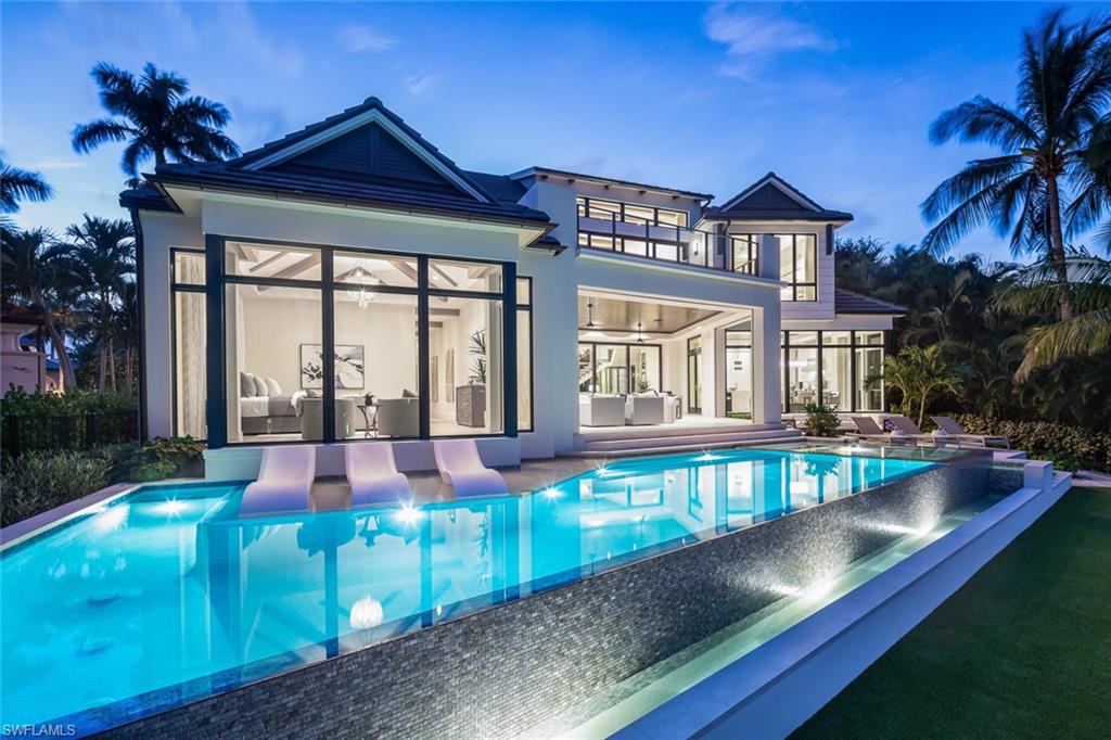 3131 Gin Lane Naples, FL 34102 - Photo 32 of 33 a view of an house with swimming pool and porch
