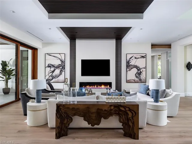 a living room with furniture a rug and a fireplace