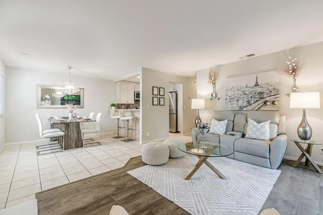 a living room with furniture and a chandelier
