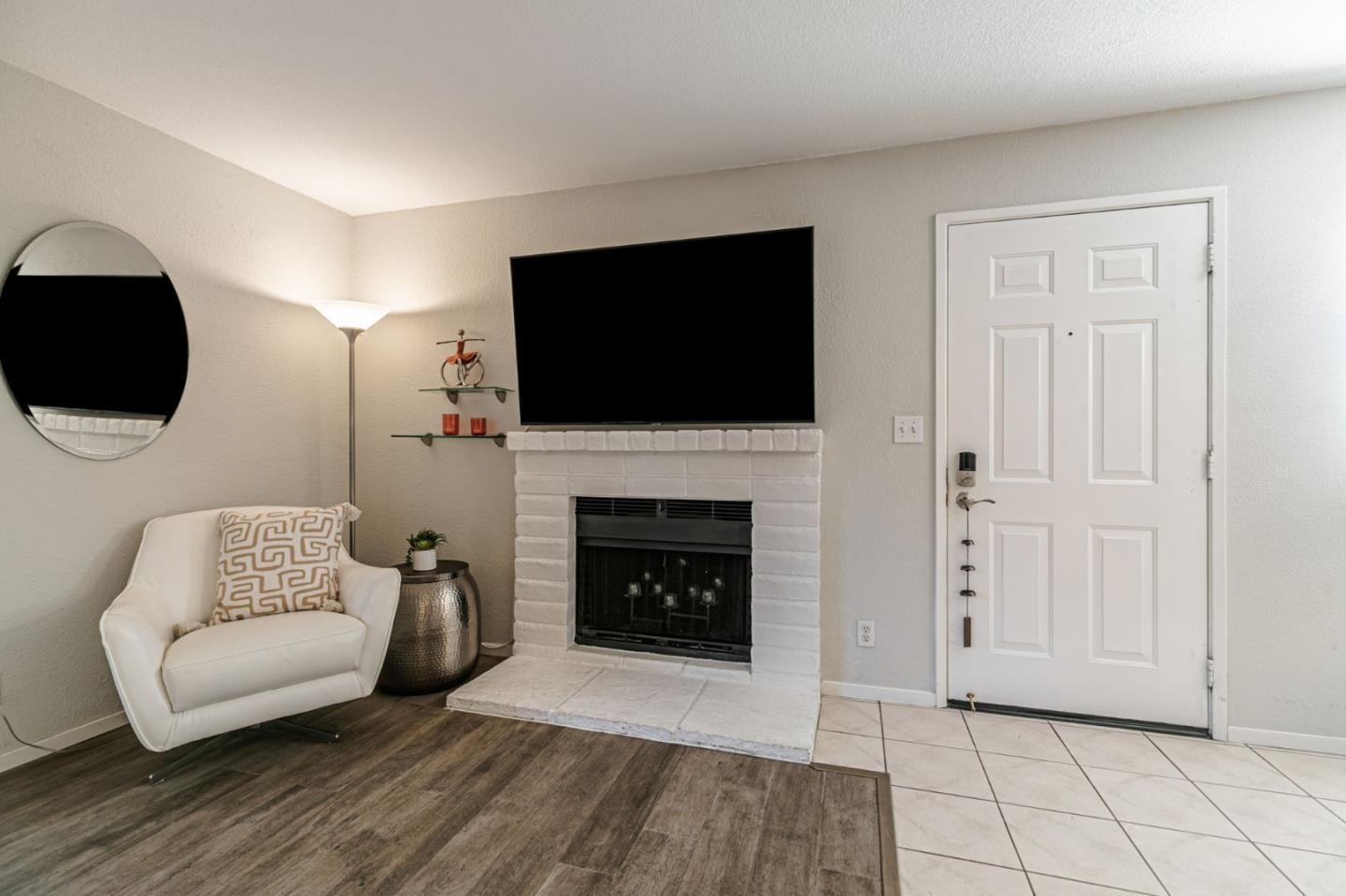3400 La Terrace Circle San Jose, CA 95123 - Photo 6 of 39 a living room with furniture a flat screen tv and a fireplace