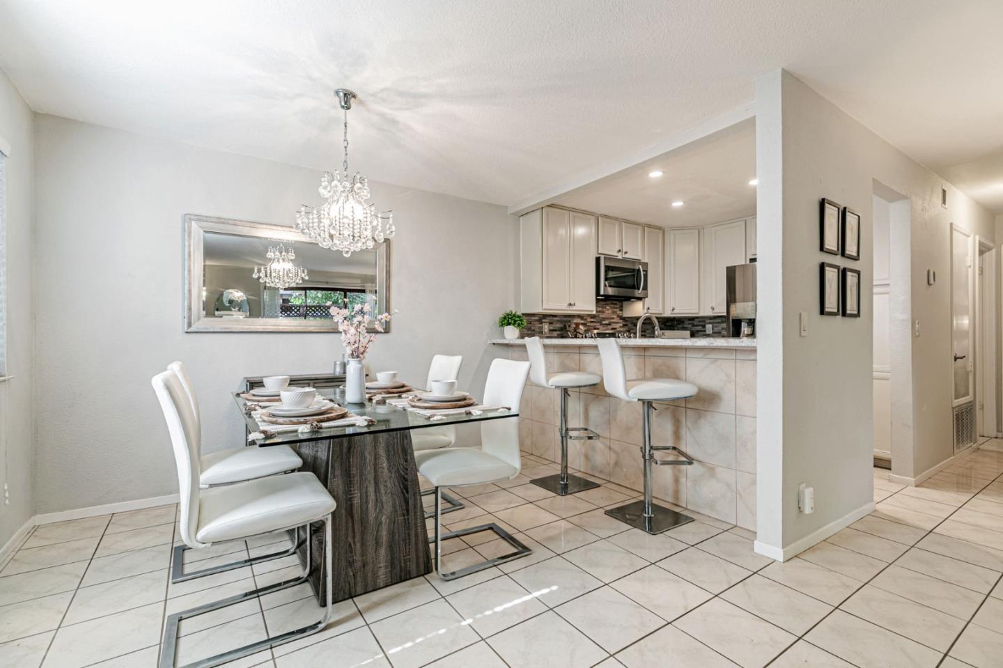 3400 La Terrace Circle San Jose, CA 95123 - Photo 7 of 39 a dining room filled a chandelier and kitchen view